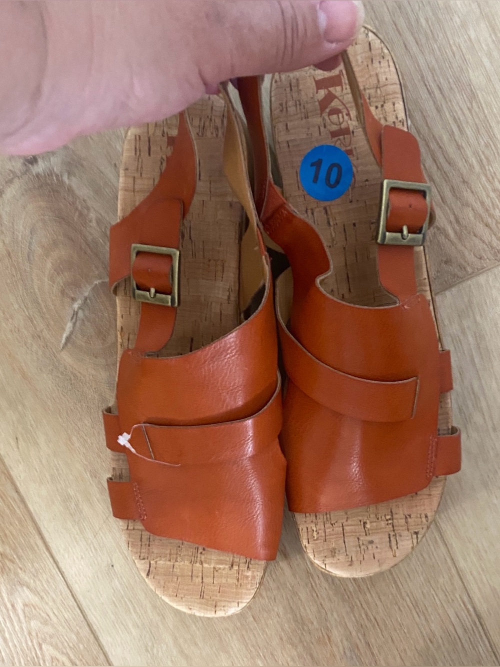 Women’s Korks platform wedge sandals feature a cork sole slingback buckle.
